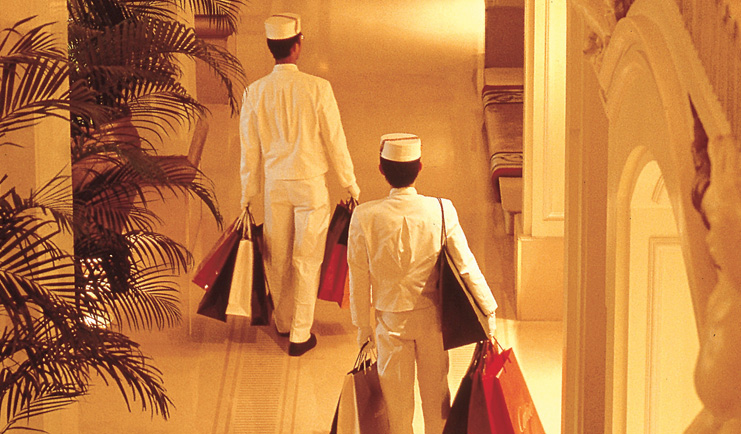 The Peninsula Hong Kong hotel service uniformed staff members carrying shopping bags