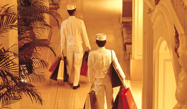 The Peninsula Hong Kong hotel service uniformed staff members carrying shopping bags