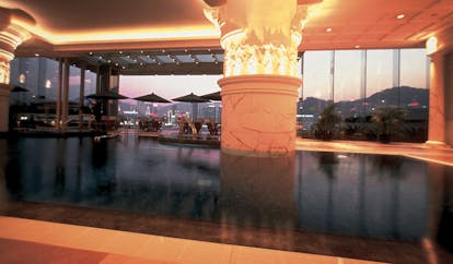 The Peninsula Hong Kong indoor pool columns panoramic city view