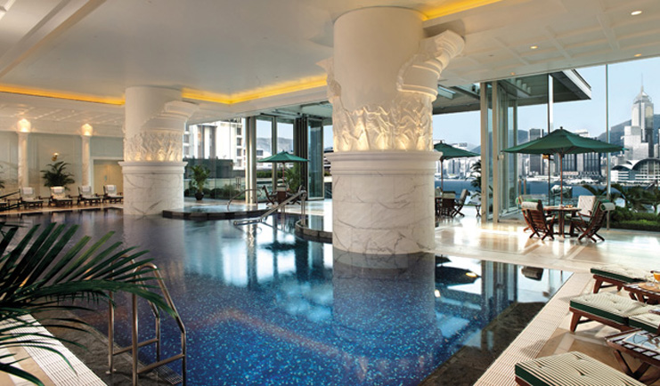 The Peninsula Hong Kong indoor swimming pool loungers seating area panoramic city view