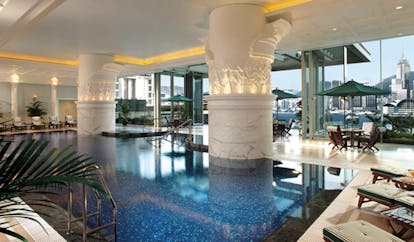 The Peninsula Hong Kong indoor swimming pool loungers seating area panoramic city view