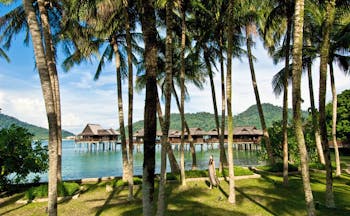 Pangkor Laut Malaysia sea villas on stilts gardens trees rainforest in background