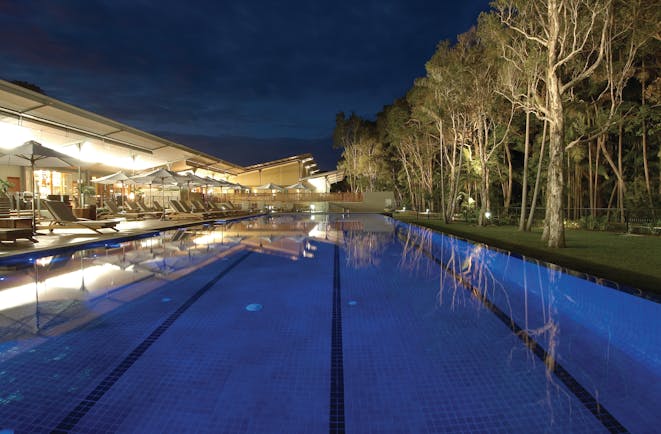 The Byron at Byron New South Wales outdoor pool with loungers and umbrellas at night