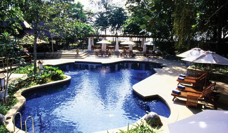 Tanjong Jara Malaysia pool sun loungers umbrellas greenery trees