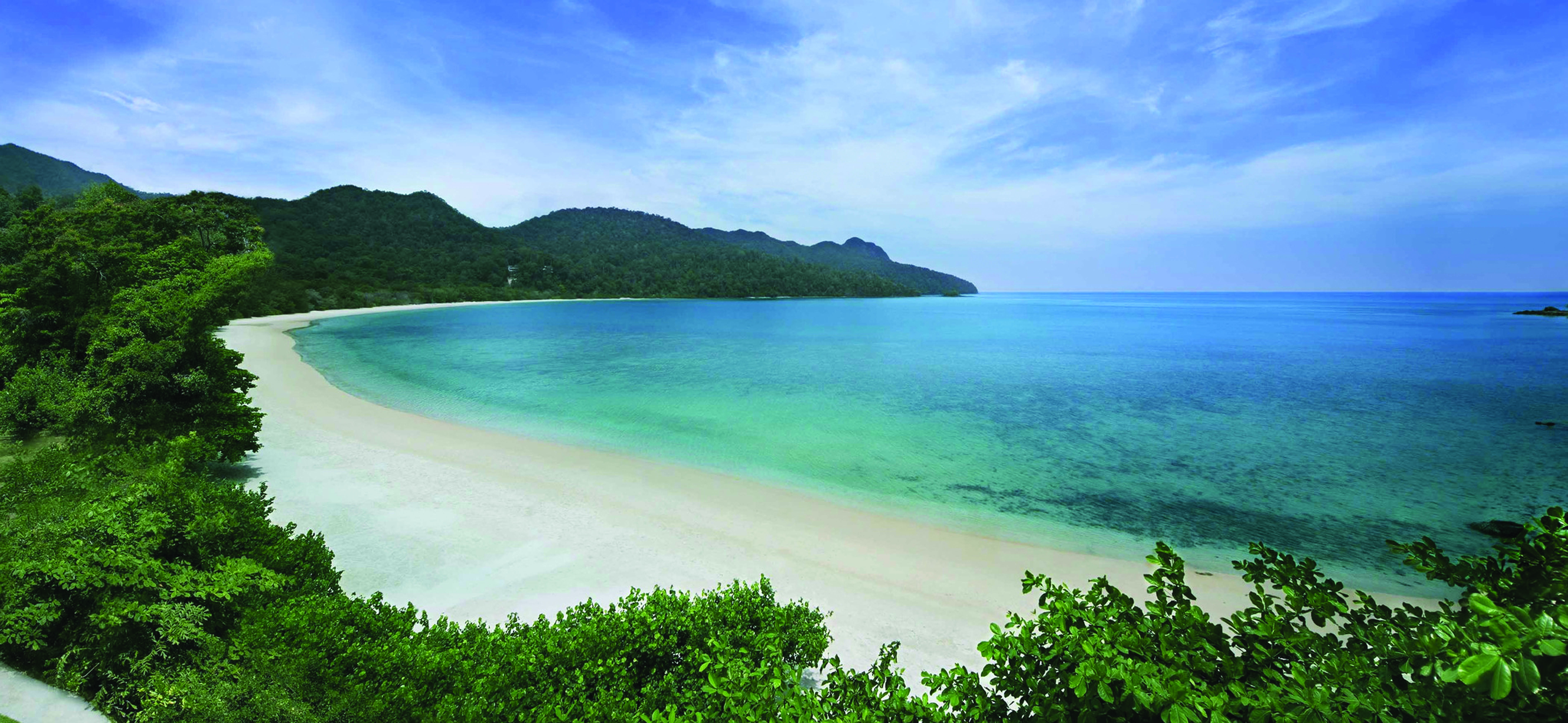 The Andaman Langkawi Malaysia beach white sand sun loungers boat island in distance