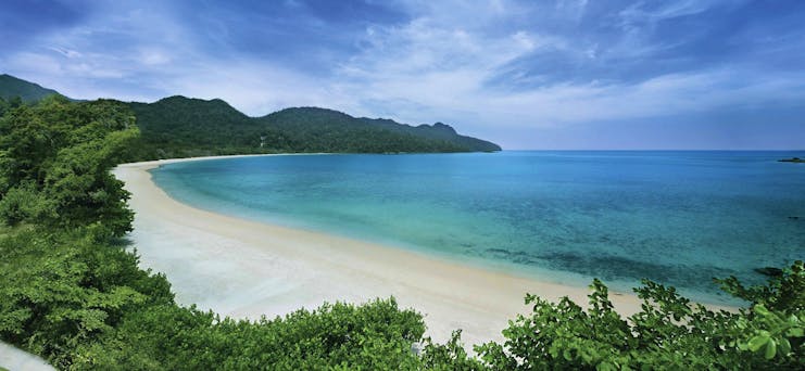 The Andaman Langkawi Malaysia beach white sand sun loungers boat island in distance