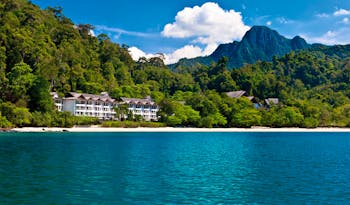 The Andaman Langkawi Malaysia hotel exterior view from the sea rainforest in background