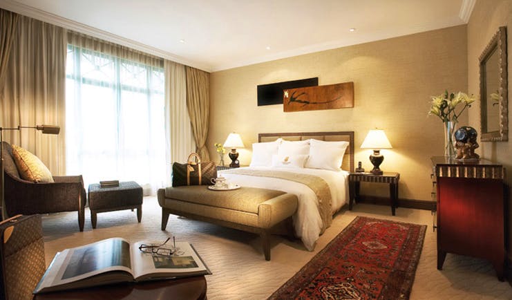 Ritz Carlton Kuala Lumpur suite bedroom bed armchair modern décor