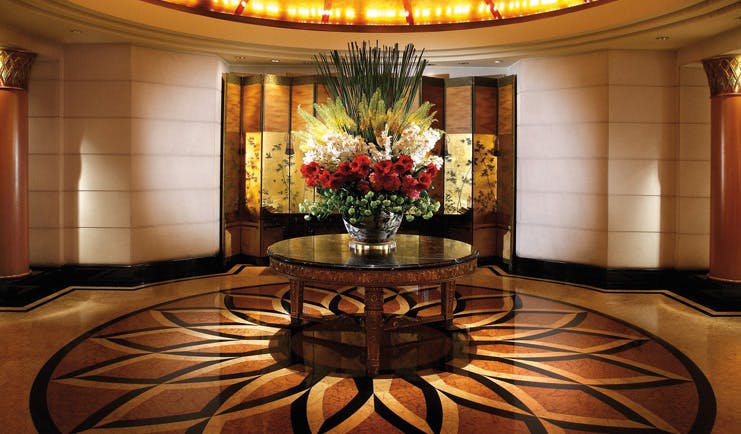 Four Seasons Singapore lobby patterned flooring large floral arrangement