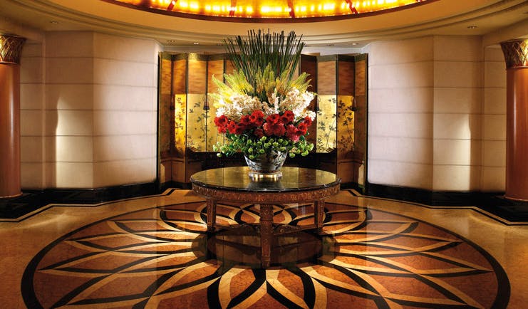 Four Seasons Singapore lobby patterned flooring large floral arrangement