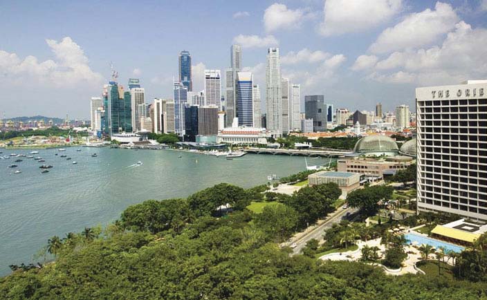 Mandarin Oriental Singapore exterior hotel building overlooking river city in background