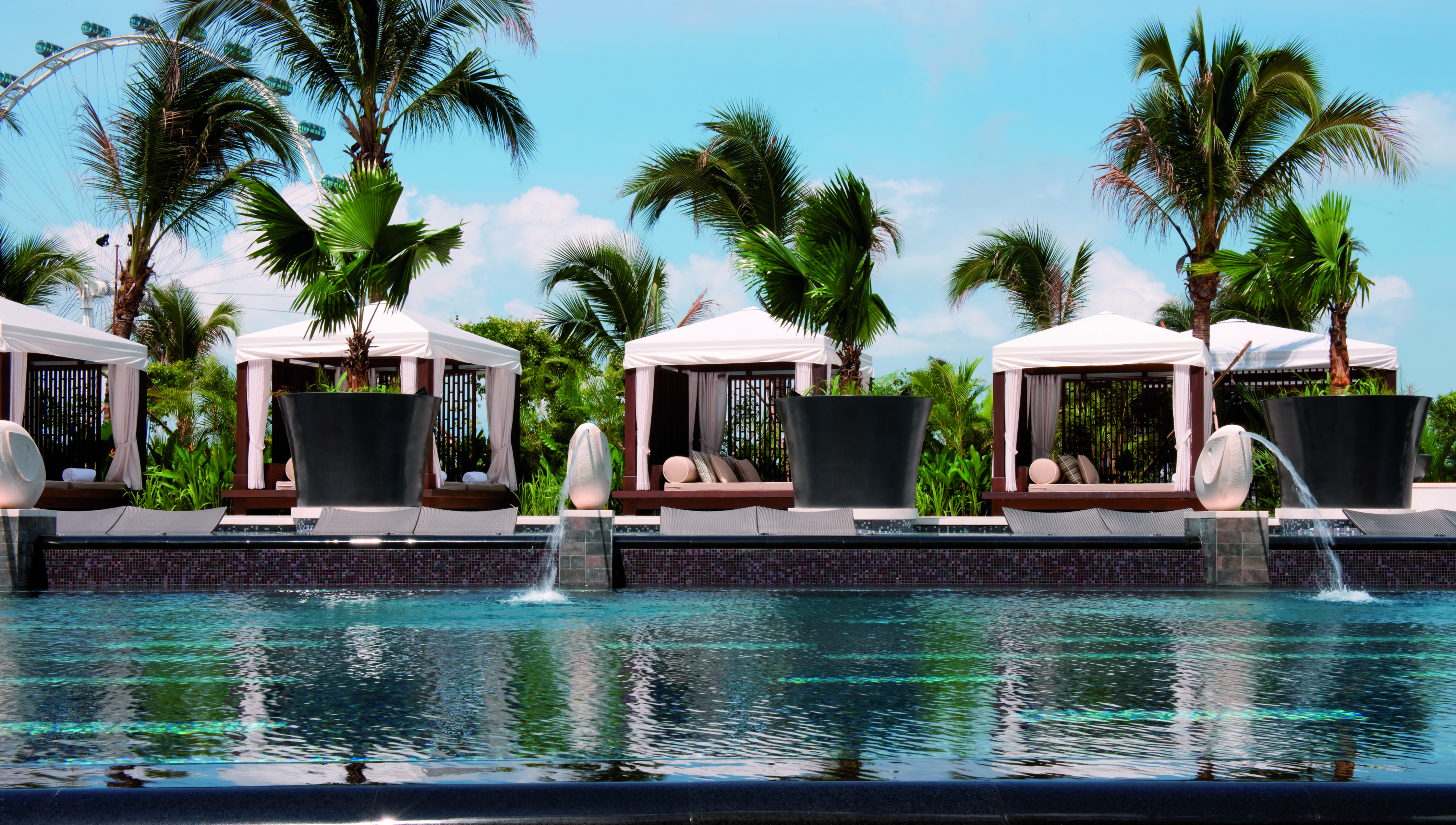 Mandarin Oriental Singapore pool sun beds cabanas palm trees