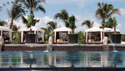 Mandarin Oriental Singapore pool sun beds cabanas palm trees