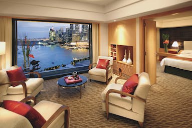 Mandarin Oriental Singapore suite lounge indoor seating area bed window overlooking harbour