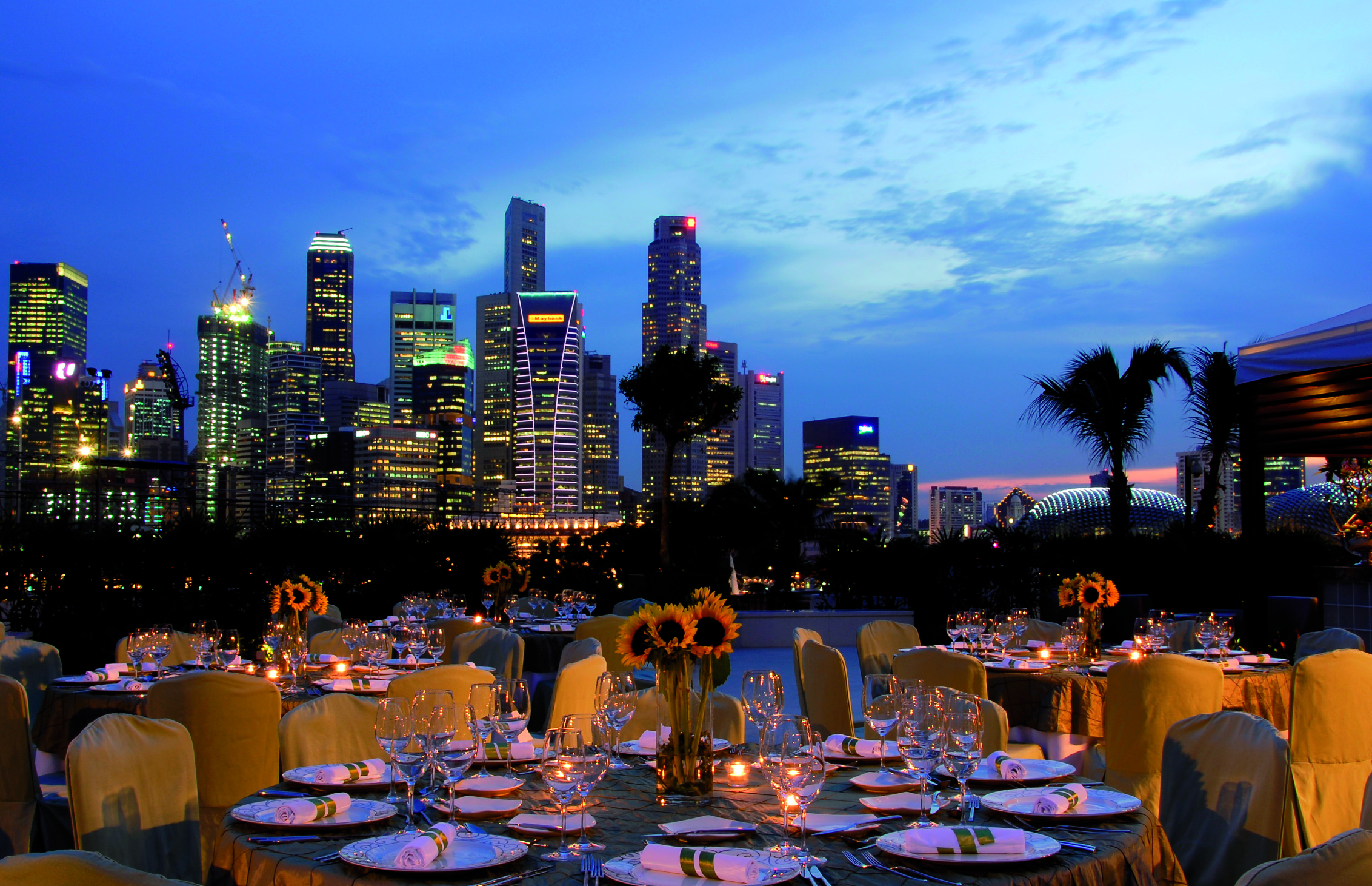Mandarin Oriental Singapore terrace outdoor dining overlooking harbour city in background