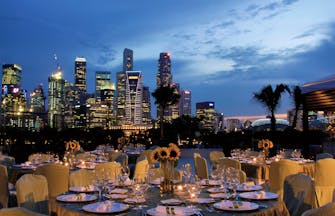 Mandarin Oriental Singapore terrace outdoor dining overlooking harbour city in background