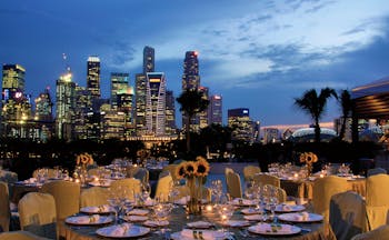 Mandarin Oriental Singapore terrace outdoor dining overlooking harbour city in background