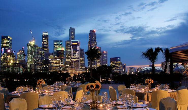 Mandarin Oriental Singapore terrace outdoor dining overlooking harbour city in background
