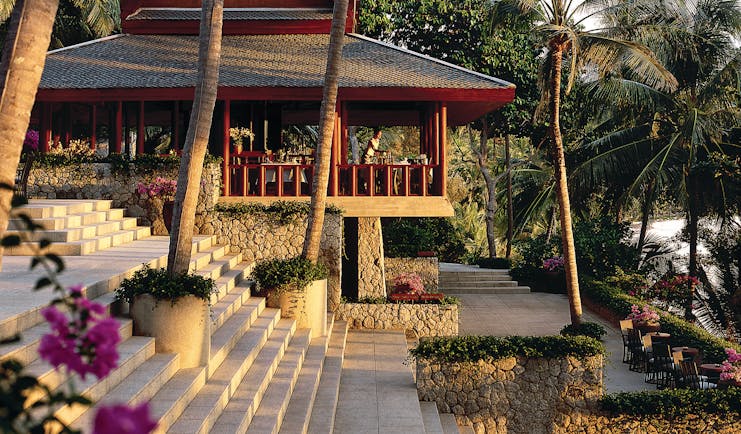 Amanpuri hotel exterior and garden with palm trees and flowers