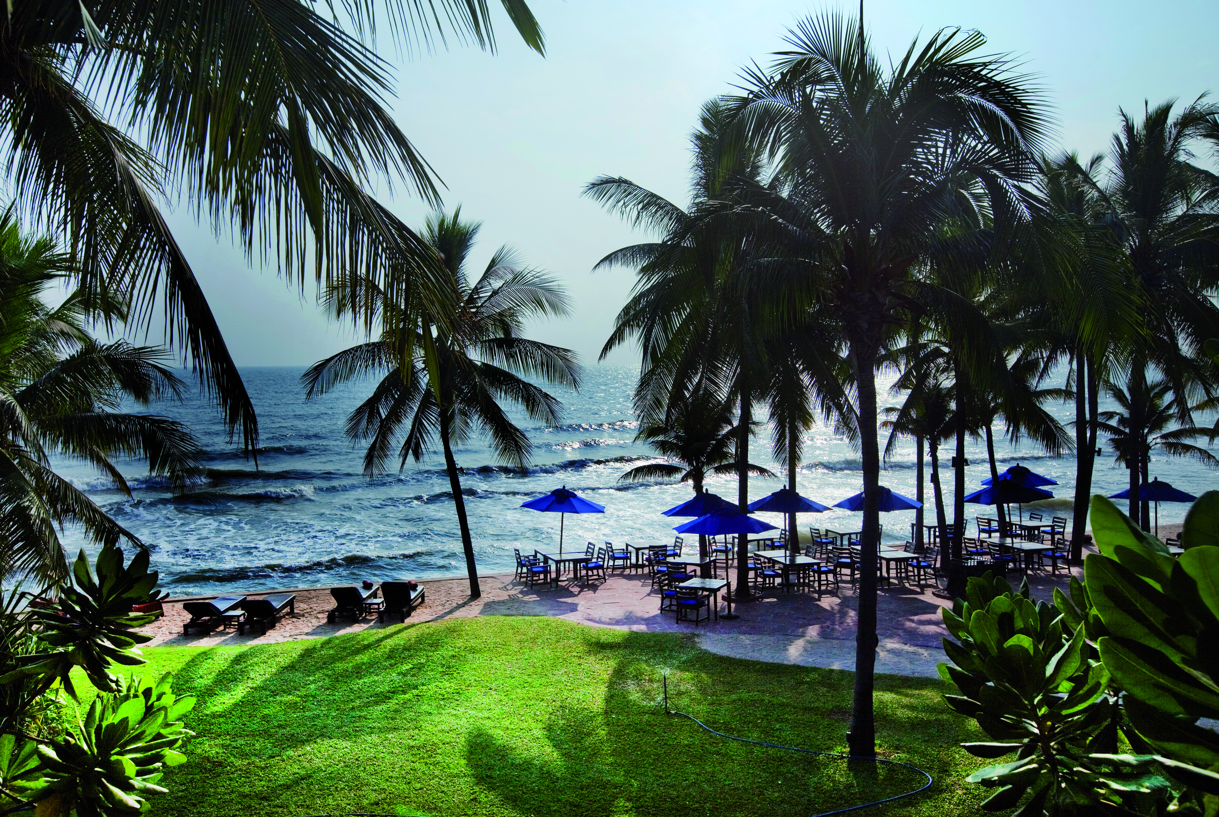 Anantara Hua Hin Thailand beach sun loungers umbrellas outdoor seating palm trees