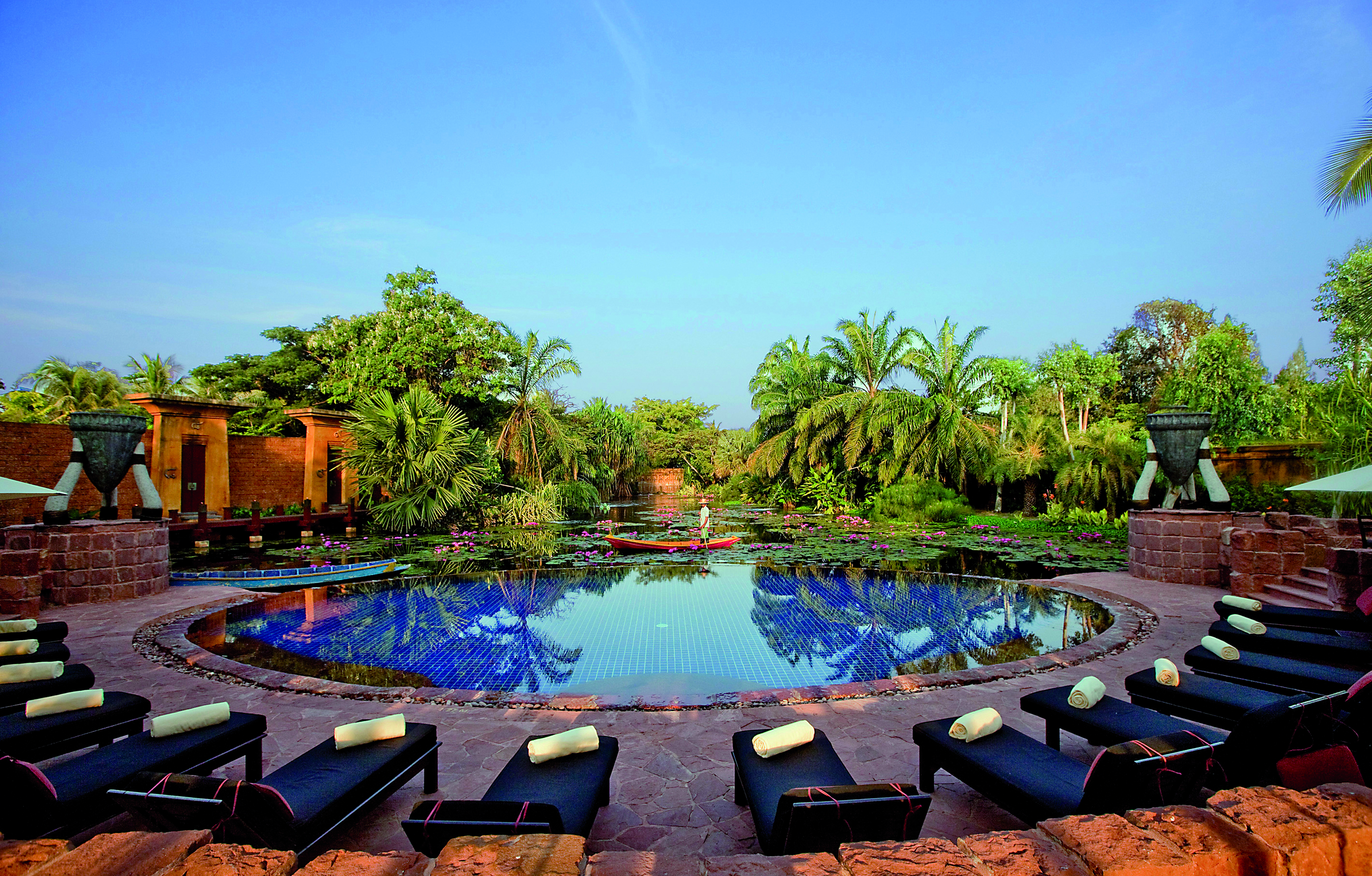 Anantara Hua Hin Thailand pool sun loungers overlooking lagoon trees