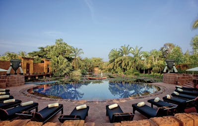 Anantara Hua Hin Thailand pool sun loungers overlooking lagoon trees