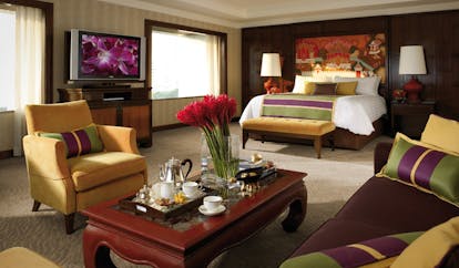 Anantara Siam Bangkok Thailand suite bedroom sitting area with sofa and tea tray