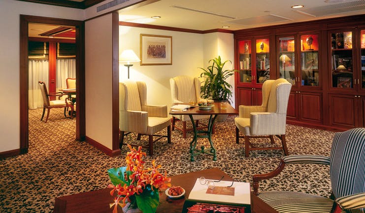 Anantara Siam Bangkok Thailand suite lounge classic decor seating area cabinets with antiques