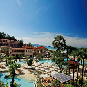 Centara Grand Beach Resort Thailand exterior hotel buildings pools sun loungers sea in background