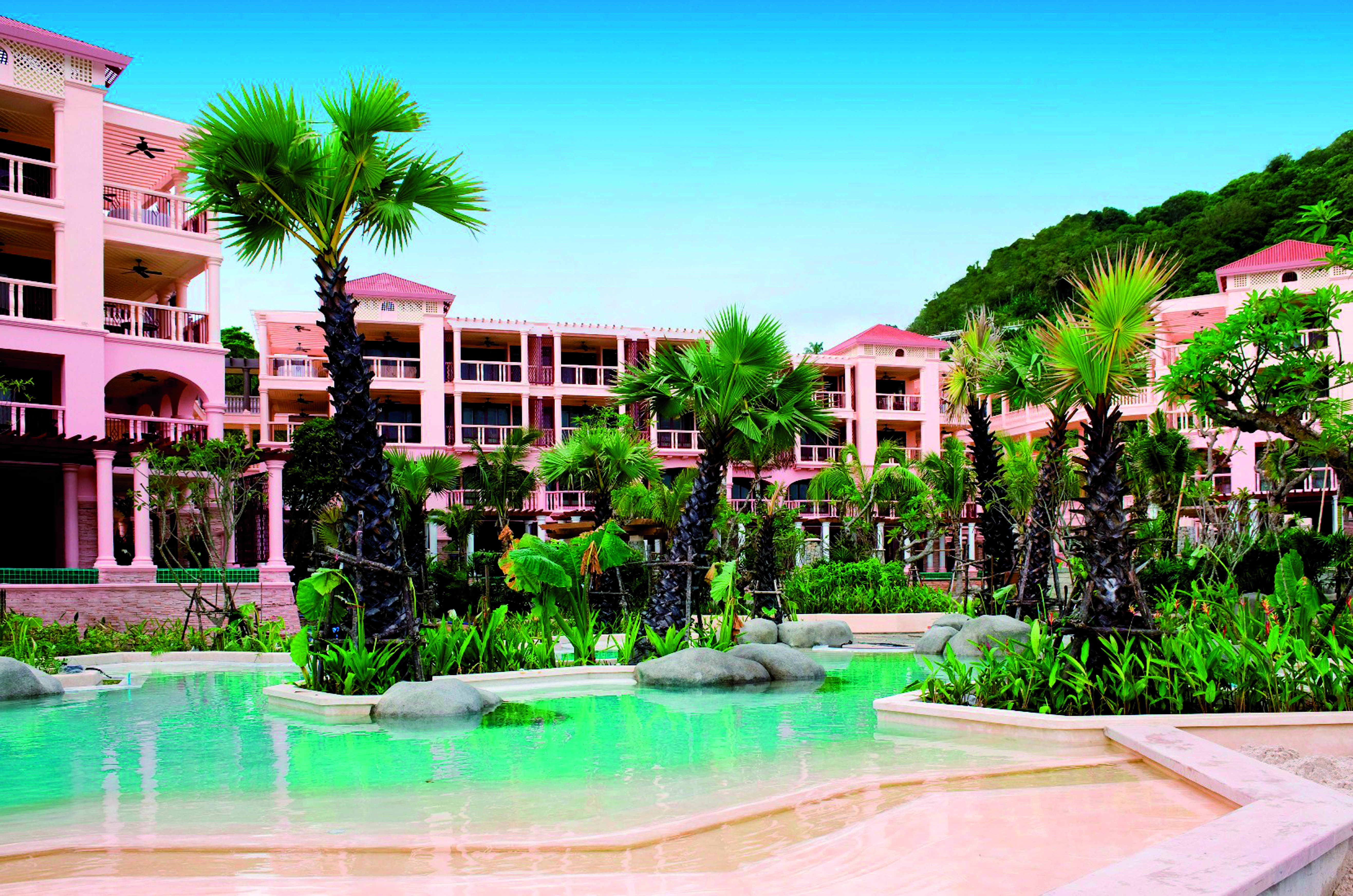 Centara Grand Beach Resort Thailand poolside sun loungers umbrellas ocean in background
