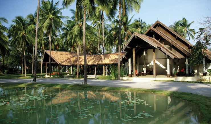 Evason Hua Hin Resort Thailand hotel reception exterior wood roof building lily pond palm trees