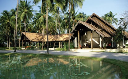 Evason Hua Hin Resort Thailand hotel reception exterior wood roof building lily pond palm trees