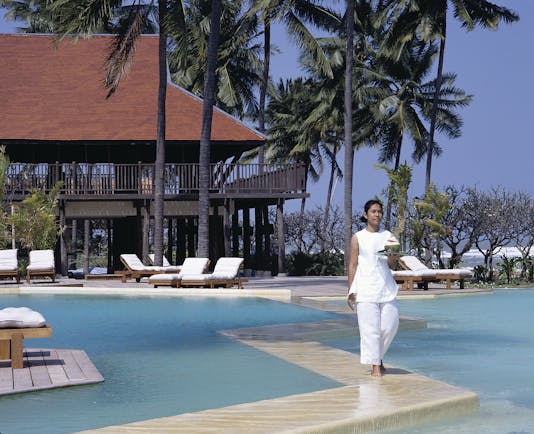 Evason Hua Hin Resort Thailand outdoor pool building with balcony overlooking outdoor pool loungers palm trees