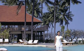 Evason Hua Hin Resort Thailand outdoor pool building with balcony overlooking outdoor pool loungers palm trees