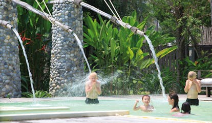 Evason Hua Hin Resort Thailand pool waterfall kids playing in a waterfall pool