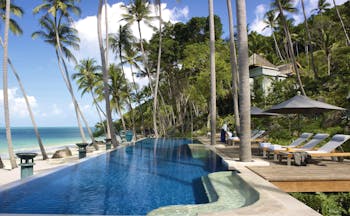 Four Seasons Koh Samui Thailand pool sun loungers umbrellas pool on beach front
