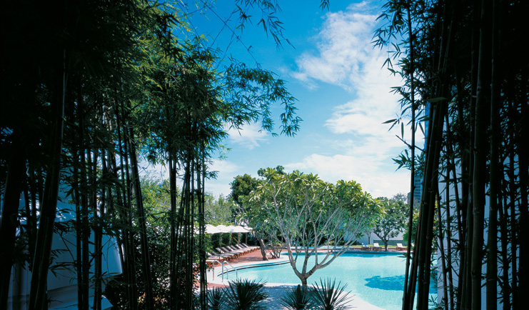 Grand Hyatt Erawan Bangkok Thailand Isawan pool outdoor pool loungers umbrellas trees