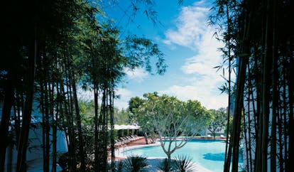 Grand Hyatt Erawan Bangkok Thailand Isawan pool outdoor pool loungers umbrellas trees
