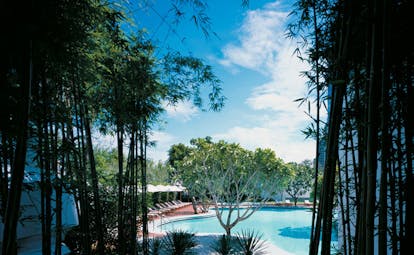 Grand Hyatt Erawan Bangkok Thailand Isawan pool outdoor pool loungers umbrellas trees
