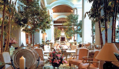 Grand Hyatt Erawan Bangkok Thailand lobby seating area opulent decor floral arrangements