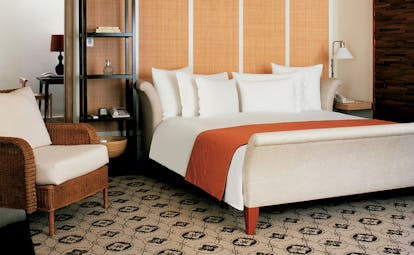 Grand Hyatt Erawan Bangkok Thailand spa cottage bedroom armchair minimalist classic decor