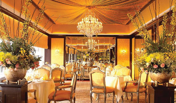 Mandarin Oriental Bangkok Thailand Le Normandie indoor dining room opulent decor floral arrangements chandeliers