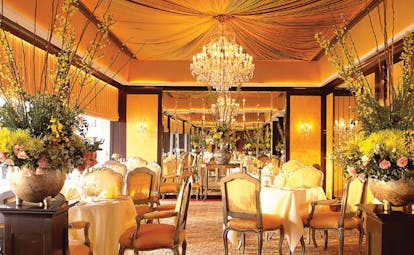 Mandarin Oriental Bangkok Thailand Le Normandie indoor dining room opulent decor floral arrangements chandeliers