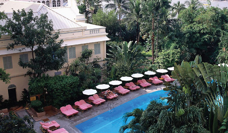 Mandarin Oriental Bangkok Thailand outdoor pool loungers umbrellas gardens trees