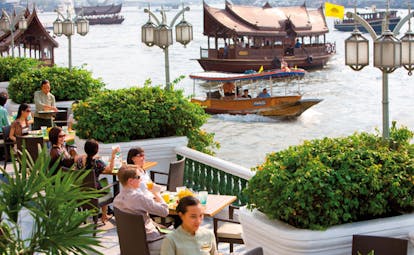Mandarin Oriental Bangkok Thailand riverside terrace outdoor dining river view boats
