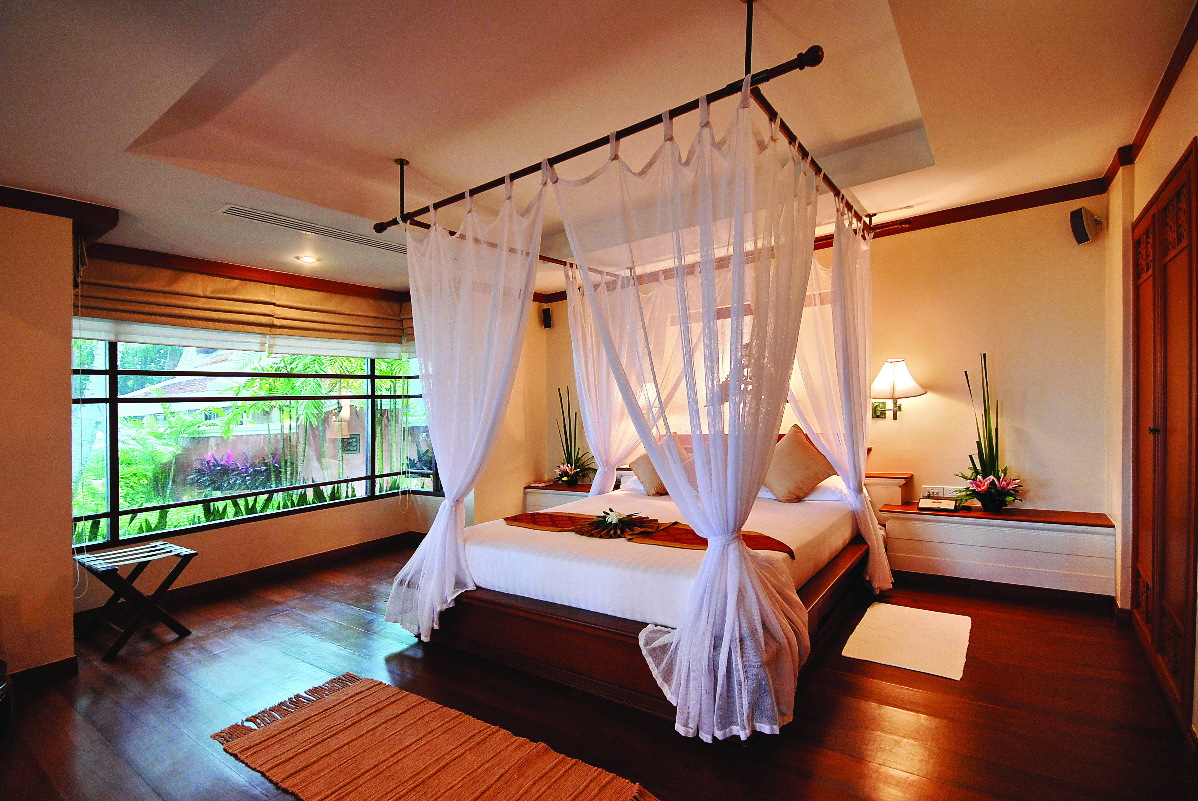 Santiburi Resort Thailand bedroom canopied bed modern décor garden views