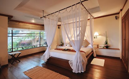 Santiburi Resort Thailand bedroom canopied bed modern décor garden views