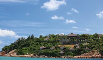 Six Senses Samui Thailand hotel exterior island with rocky beach bungalows palm trees