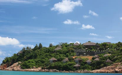 Six Senses Samui Thailand hotel exterior island with rocky beach bungalows palm trees
