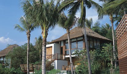 Six Senses Samui Thailand pool villa exterior thatched roofed villa palm trees
